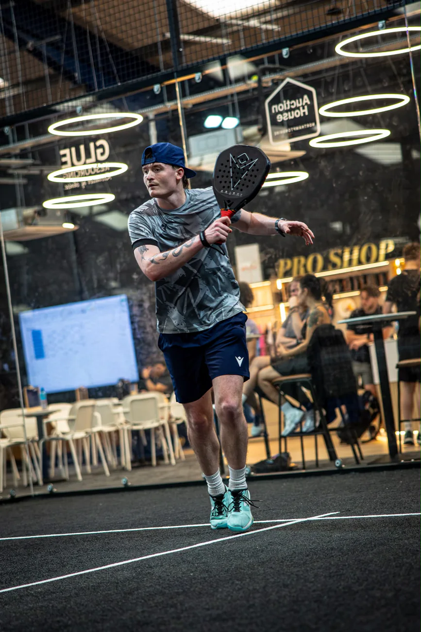 A coach playing a forehand at Padel Power