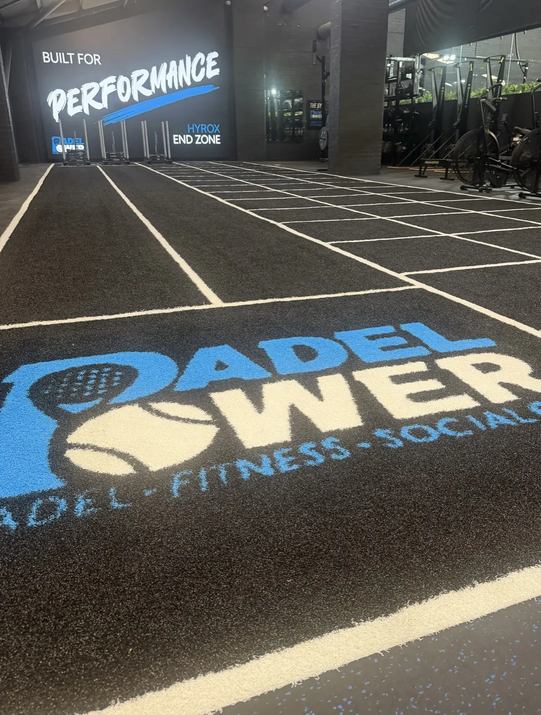 Built for Performance wall and the Padel Power logo on the HYROX turf