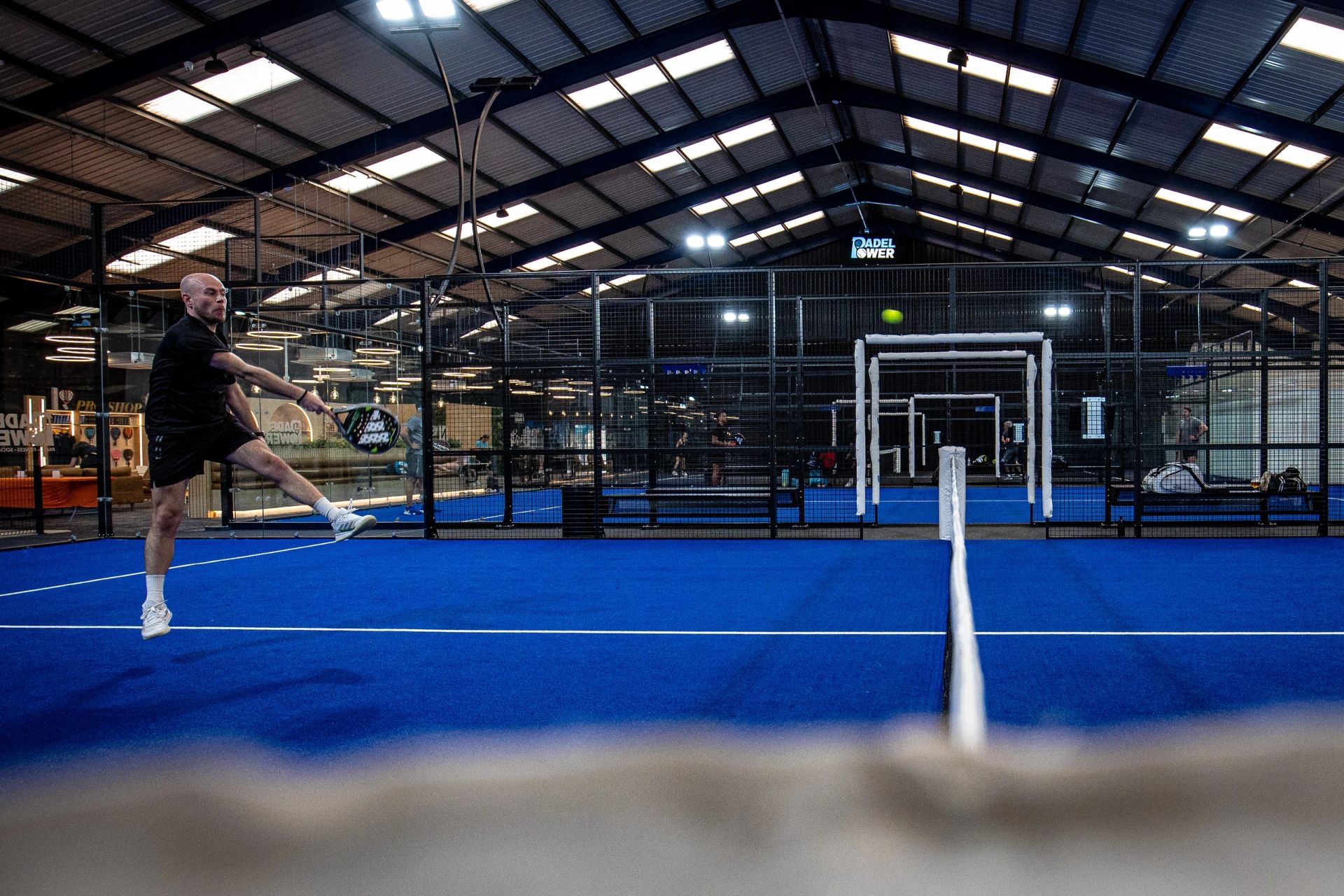 Two players celebrating a point on the indoor blue courts