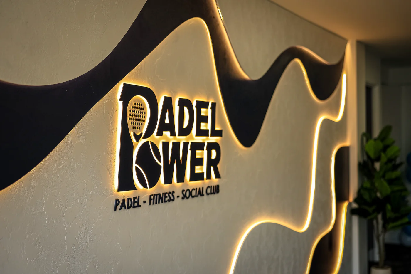 Padel Power logo on the timber wall inside the club
